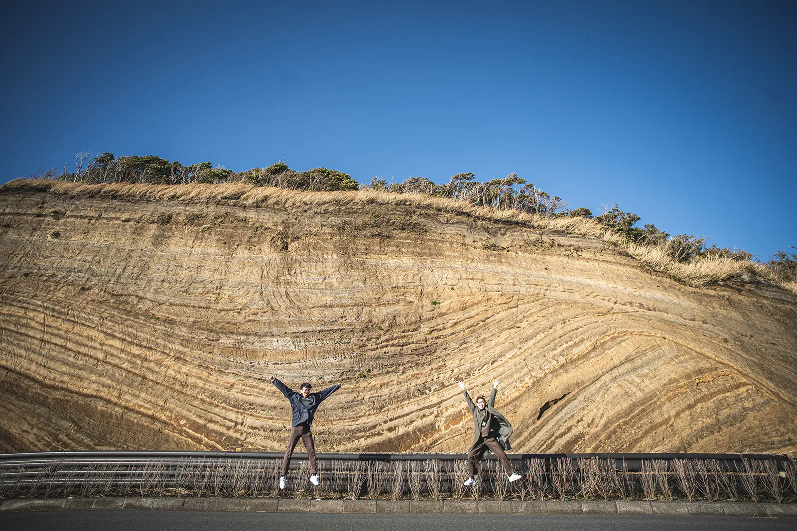 伊豆大島の大きな地層切断面と青空を写したワイド写真