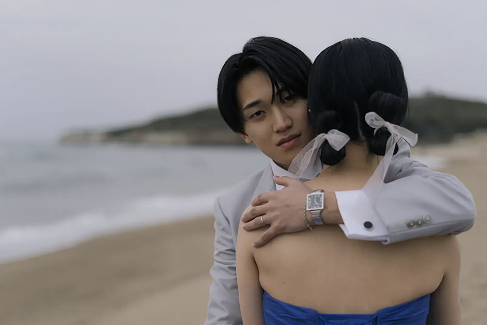 片野海岸の海辺で寄り添う新郎新婦のフォトウェディング写真