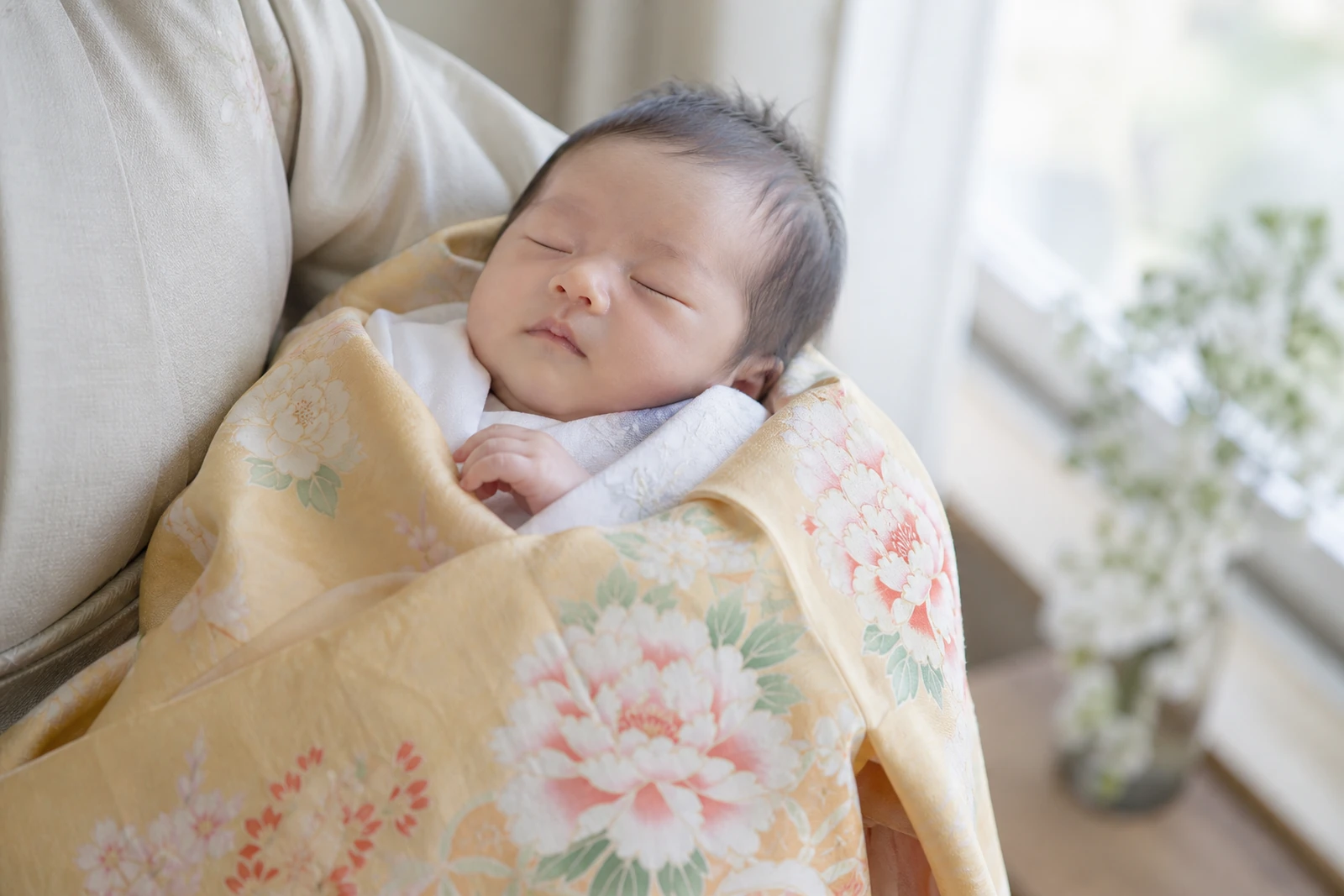 生後1か月ごろの赤ちゃん｜産着を掛けて眠っている様子