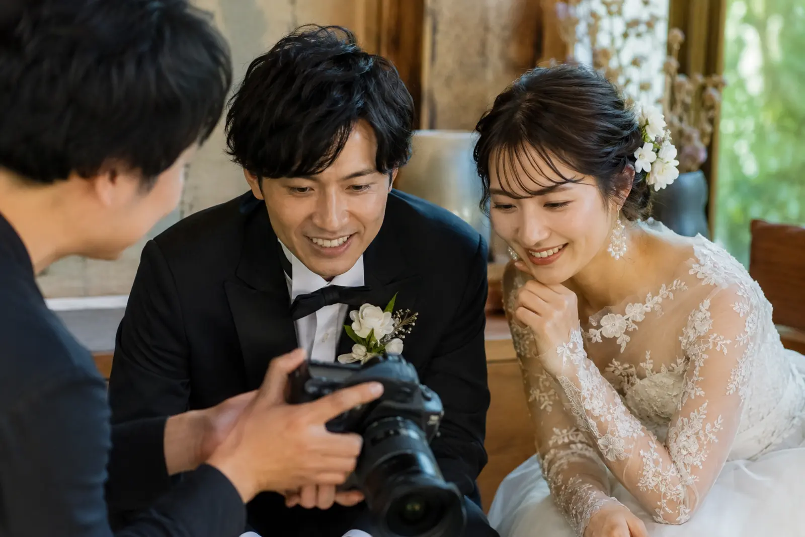 フォトウェディング撮影後に写真の仕上がりを確認する新郎新婦