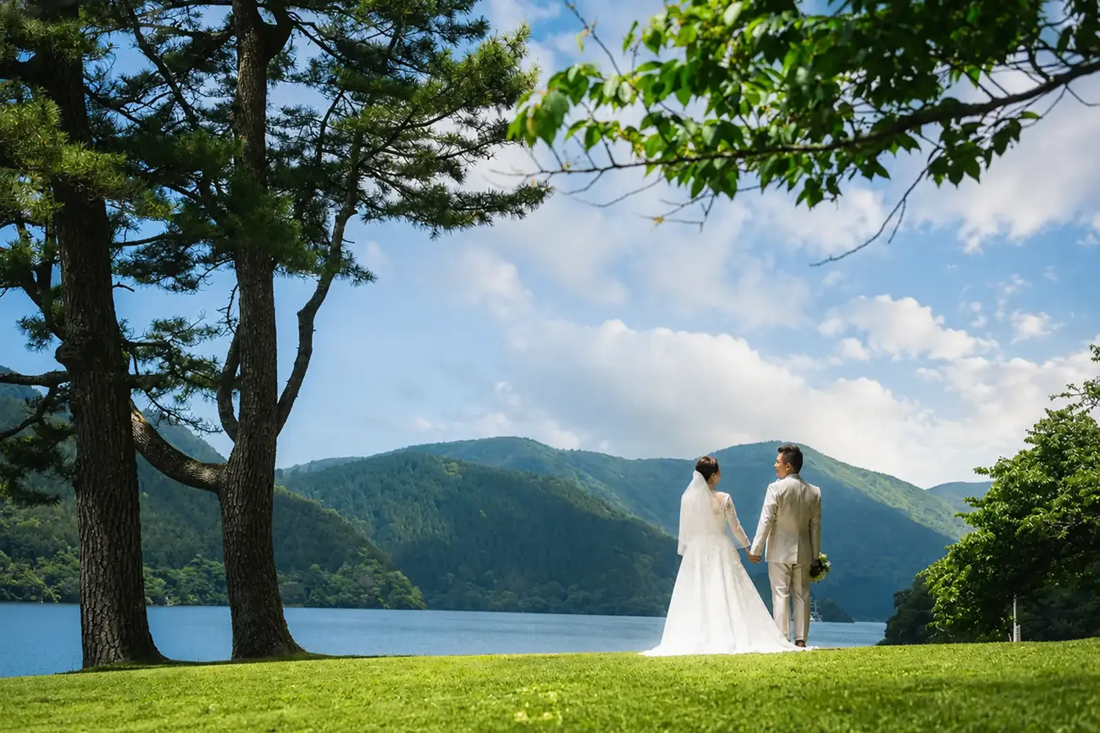 芦ノ湖の景色を背景に撮影した新郎新婦のウェディングフォト