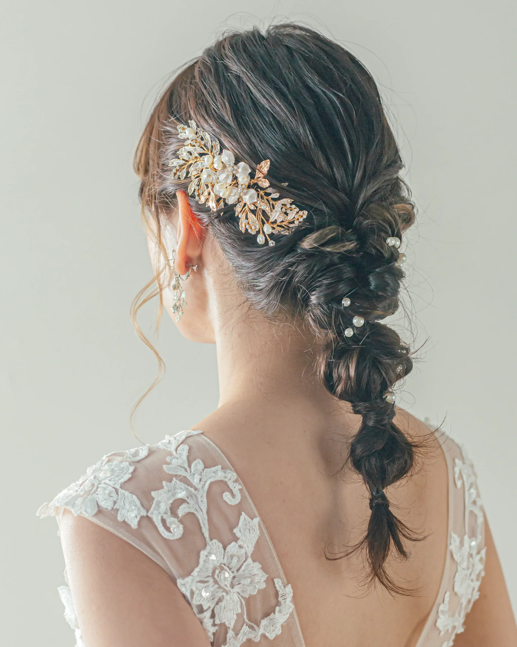 洋装のロングヘアを編みおろしにまとめ、アクセサリーを合わせた花嫁ヘアスタイル